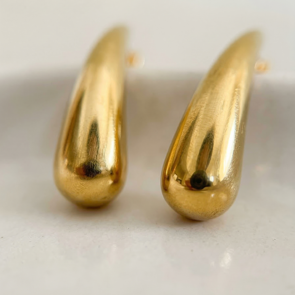 Pair of gold hoop earrings on a white background