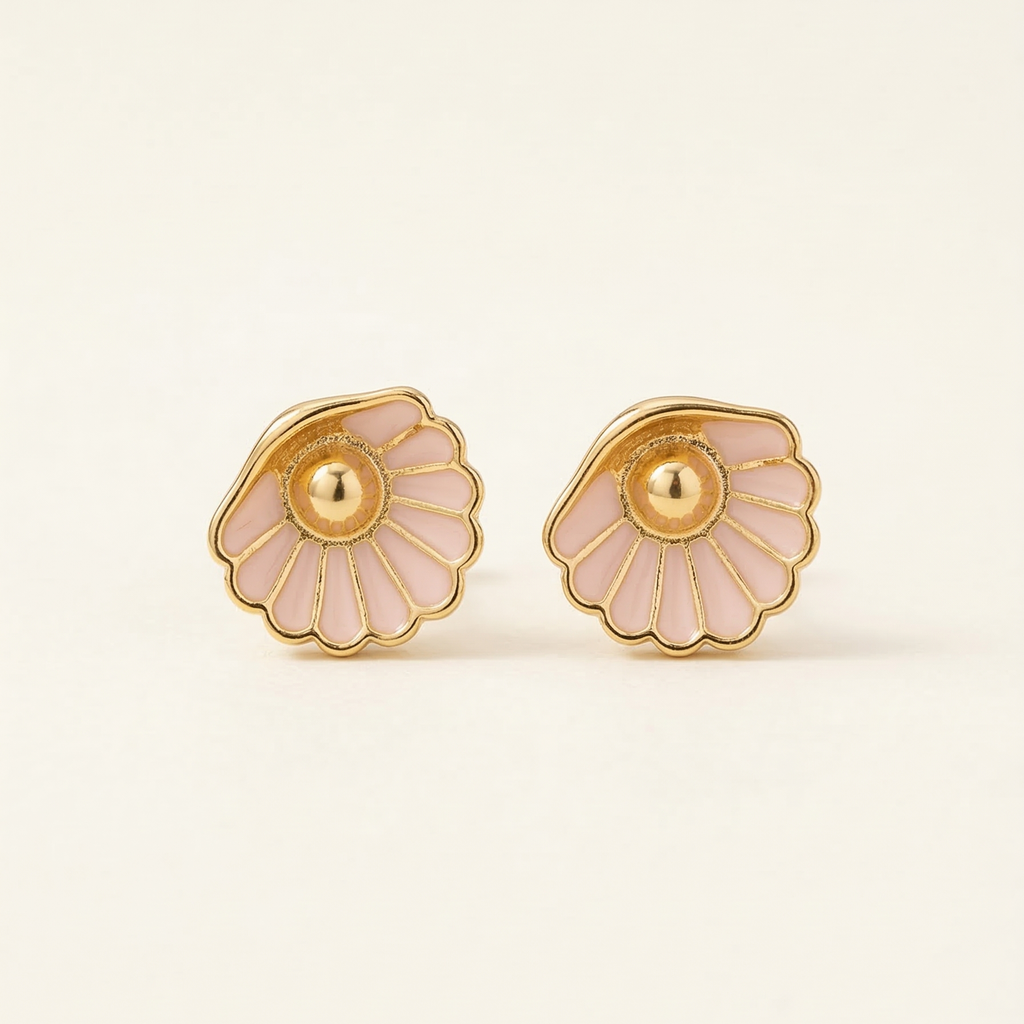 Pair of gold and pink floral earrings on a light beige background