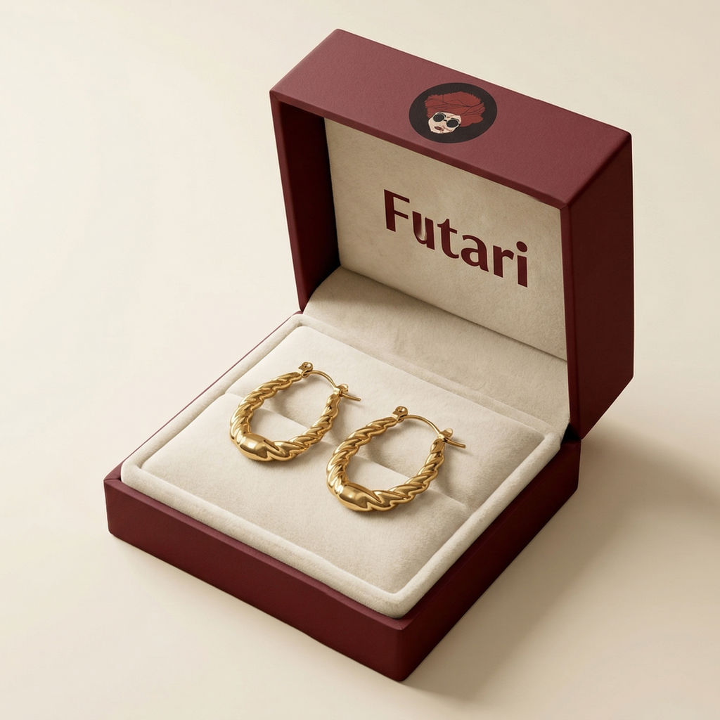 Gold hoop earrings in an open jewelry box with 'Futari' branding on a beige background