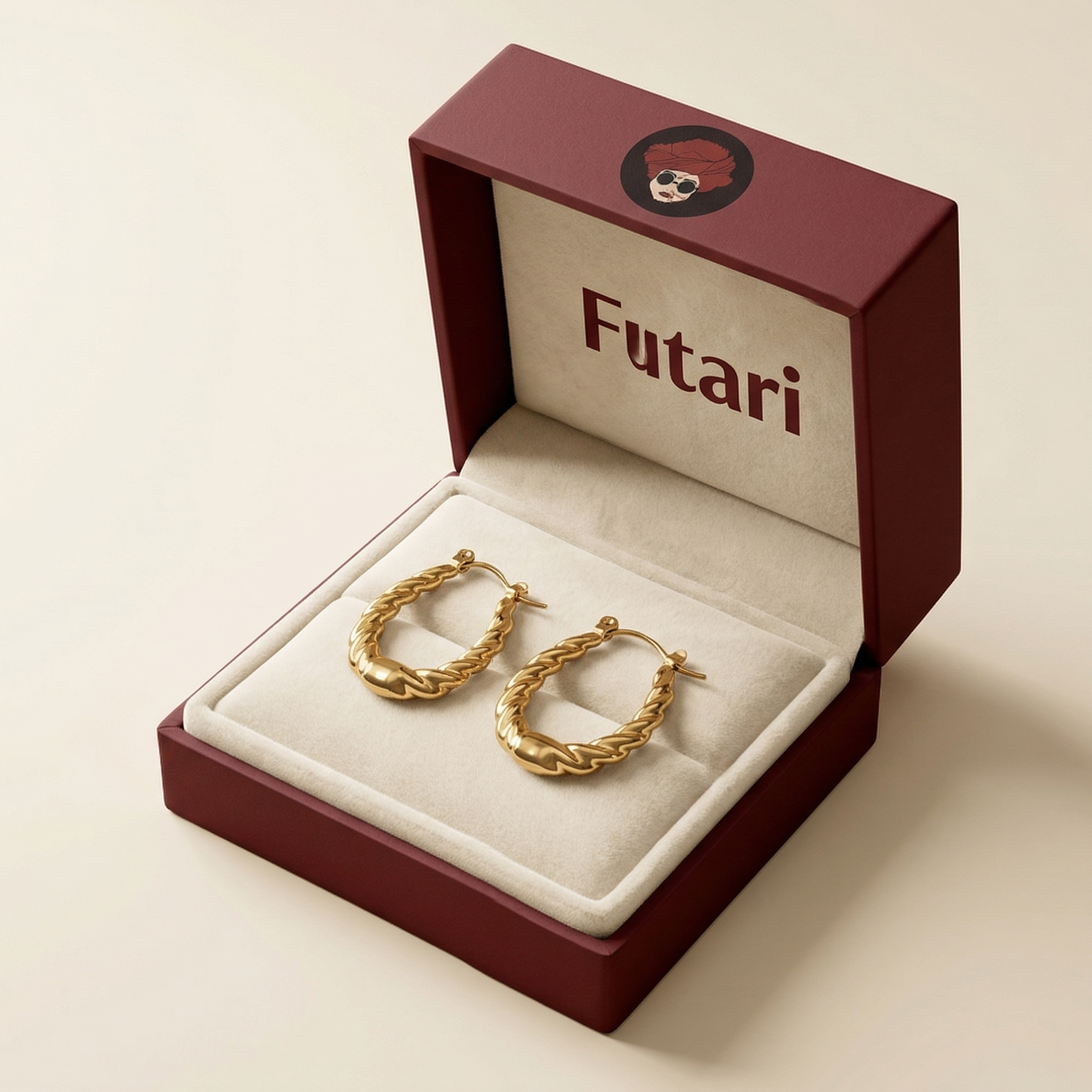 Gold hoop earrings in an open jewelry box with 'Futari' branding on a beige background