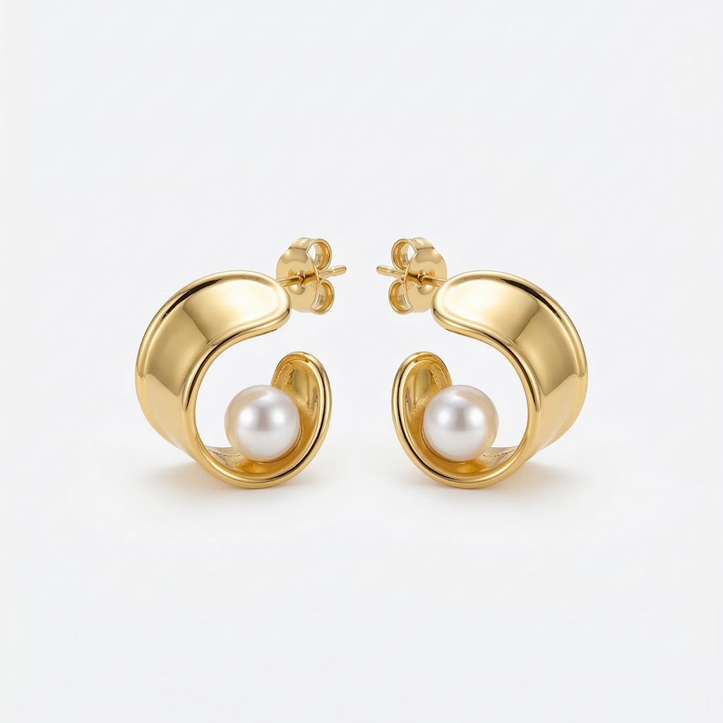 Gold hoop earrings with pearl centers on a white background