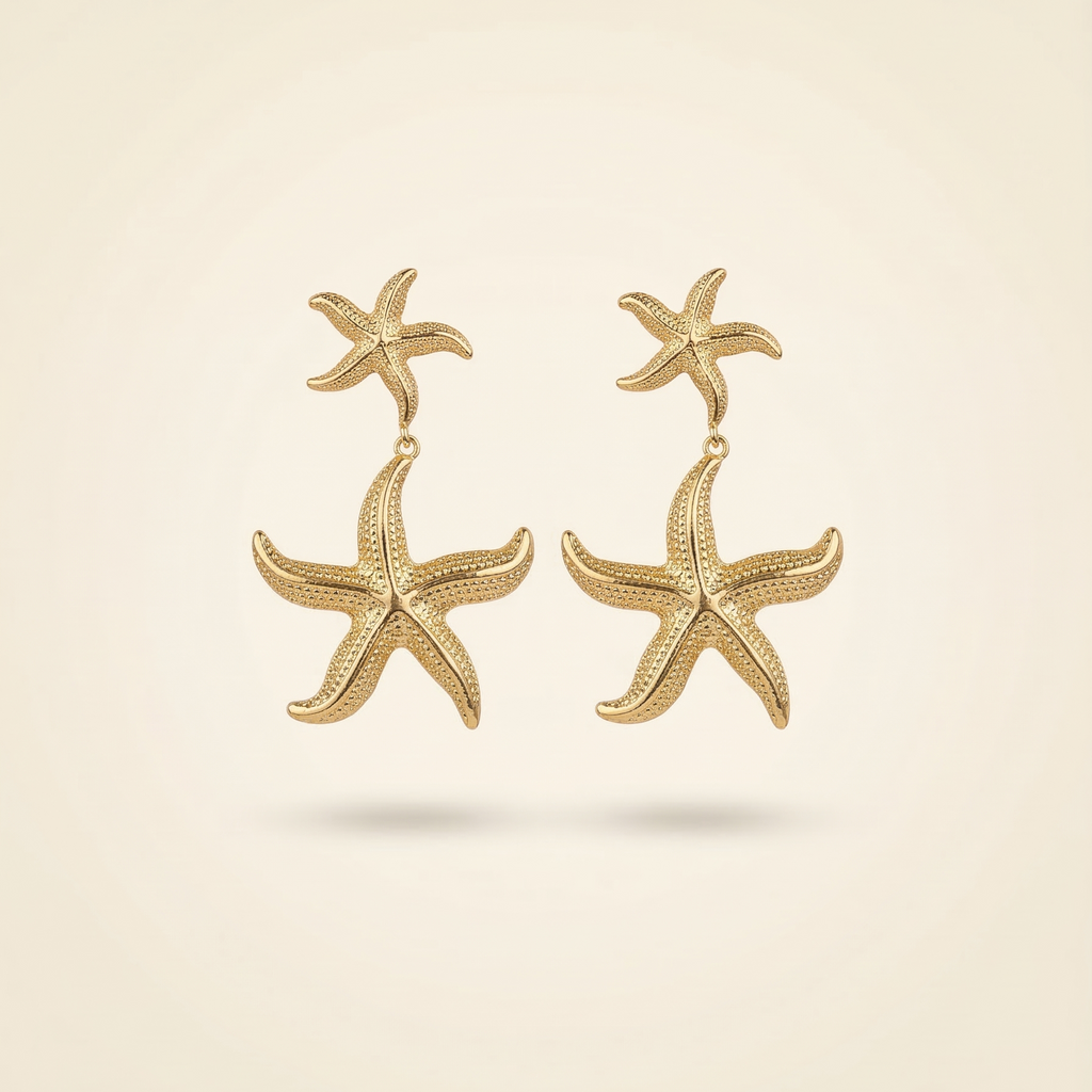 Gold starfish earrings on a beige background