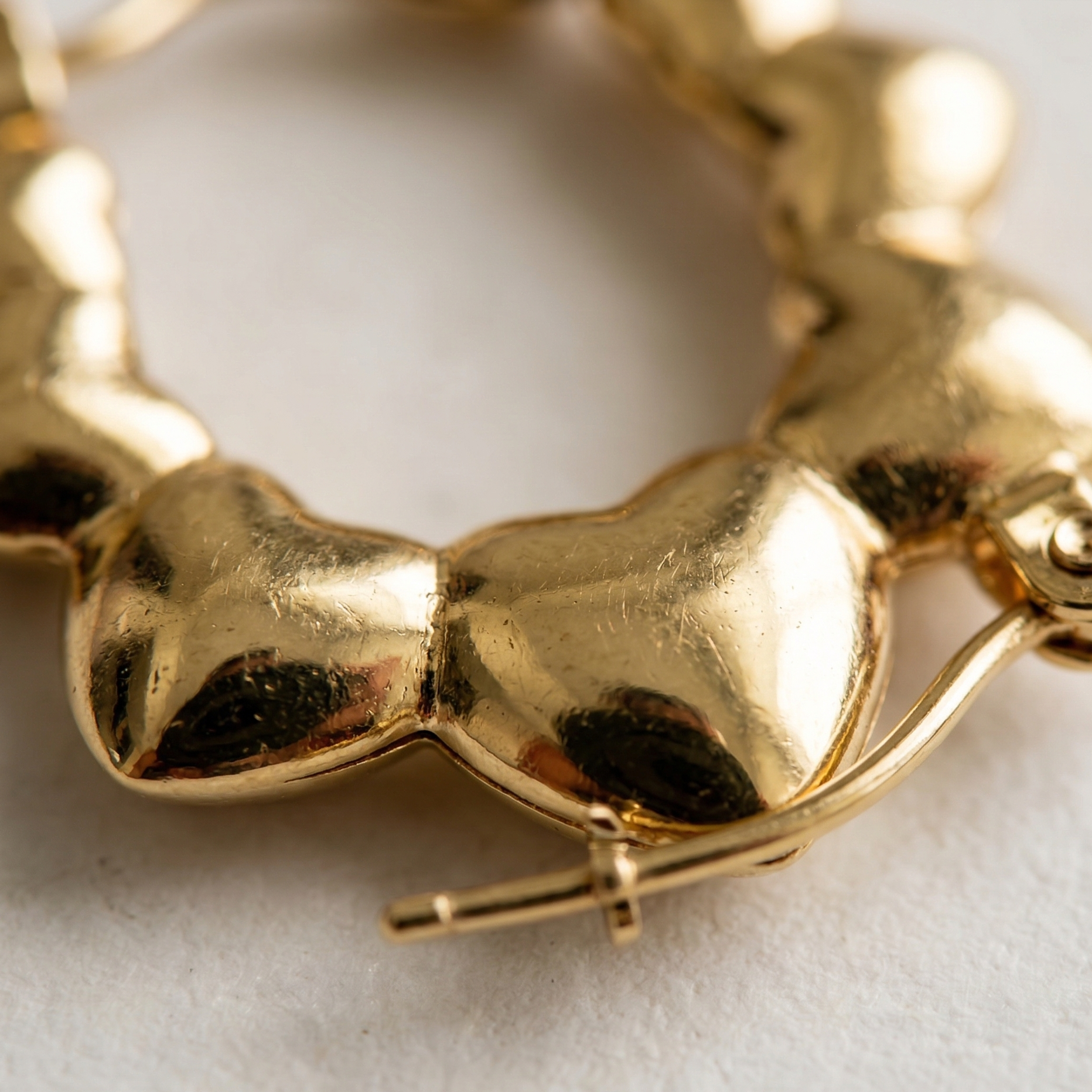 Close-up of a gold bracelet on a light background