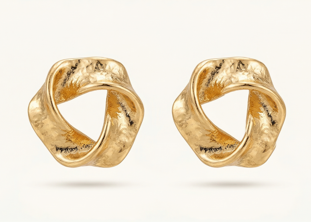 Pair of gold earrings on a white background