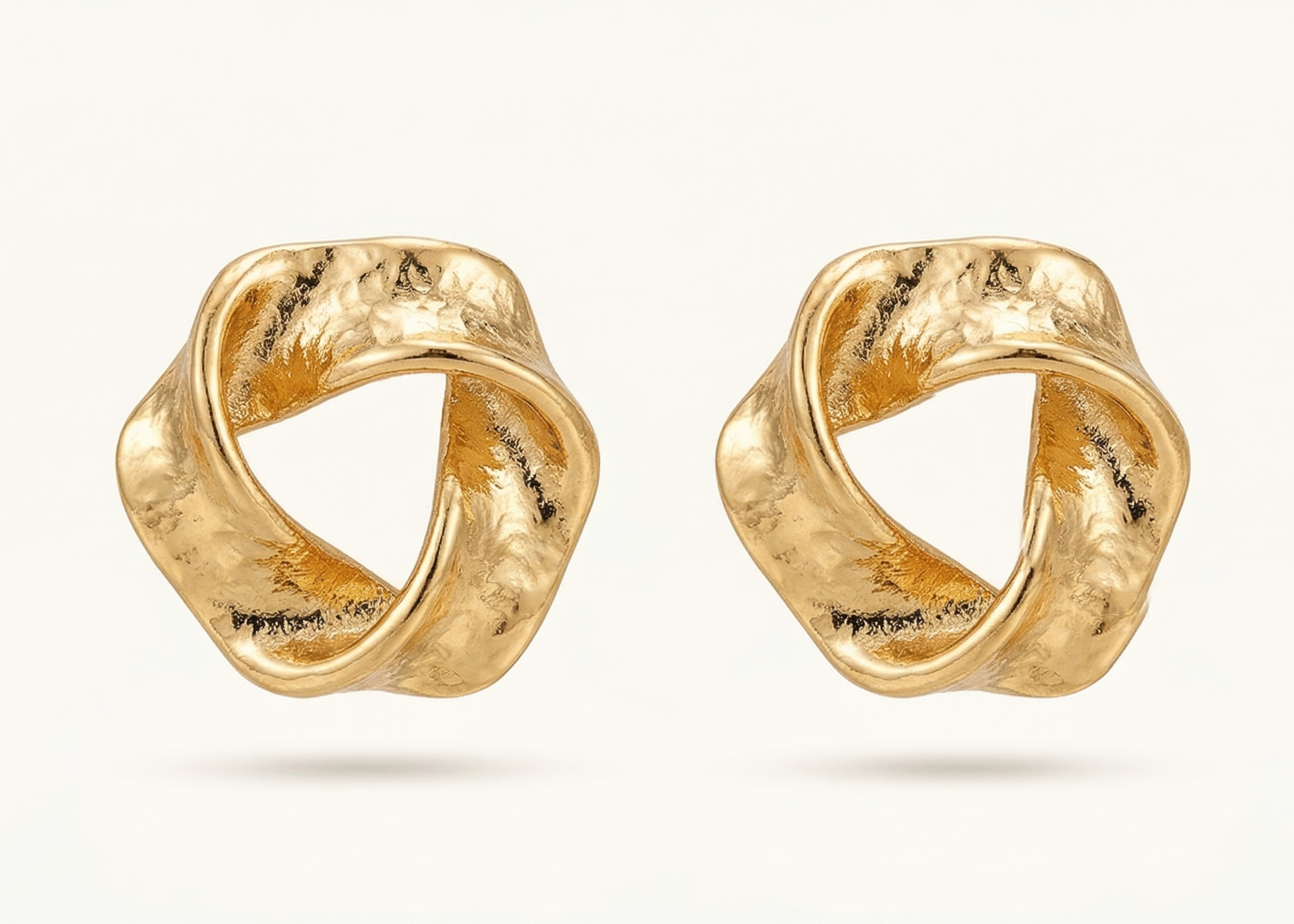 Pair of gold earrings on a white background