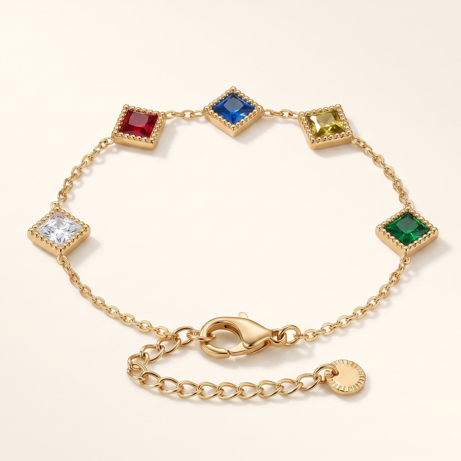 Gold bracelet with colorful gemstones on a light beige background