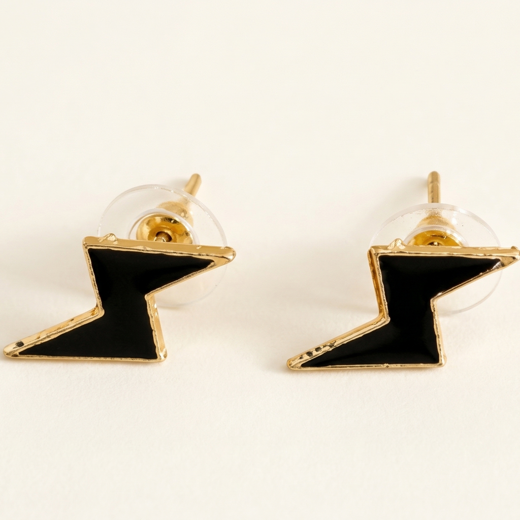 Pair of black and gold lightning bolt earrings on a white background
