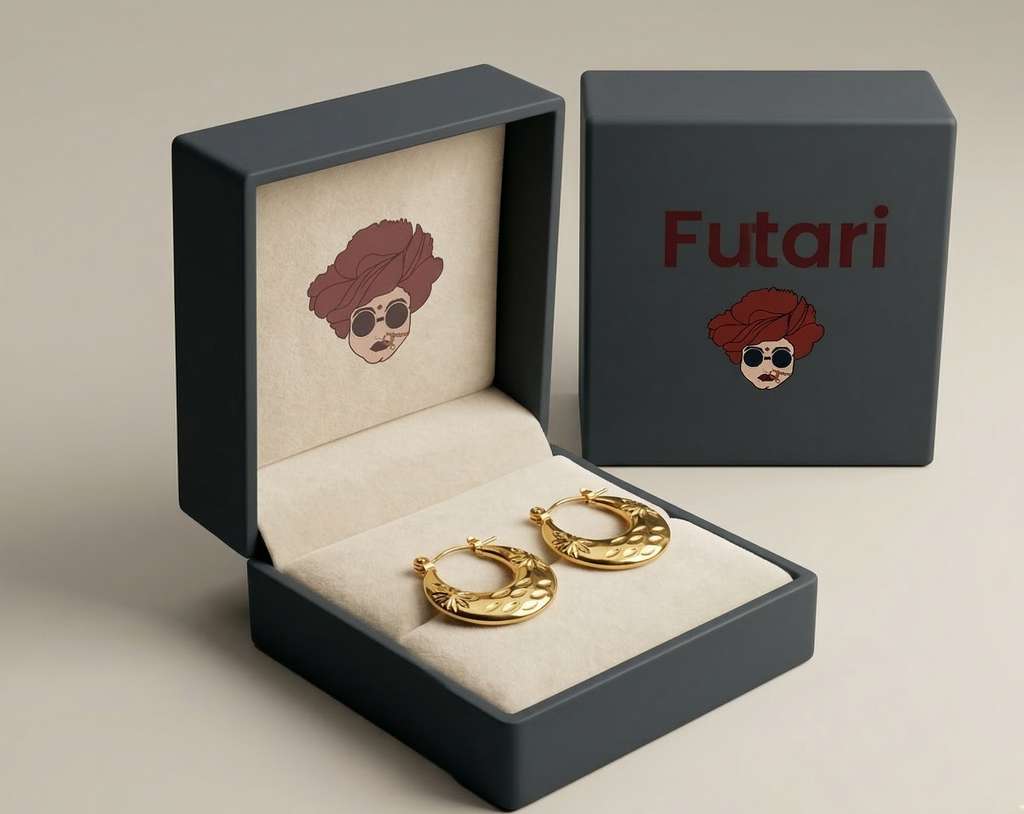 Gold hoop earrings in a 'Futari' branded box on a beige background