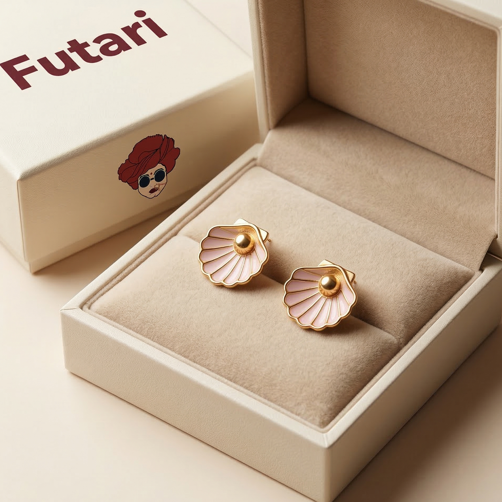 Gold shell-shaped earrings in a beige jewelry box with 'Futari' branding.
