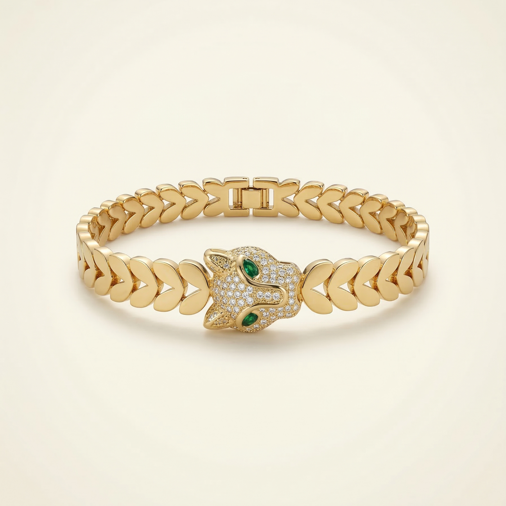 Gold bracelet with a hamsa design on a beige background