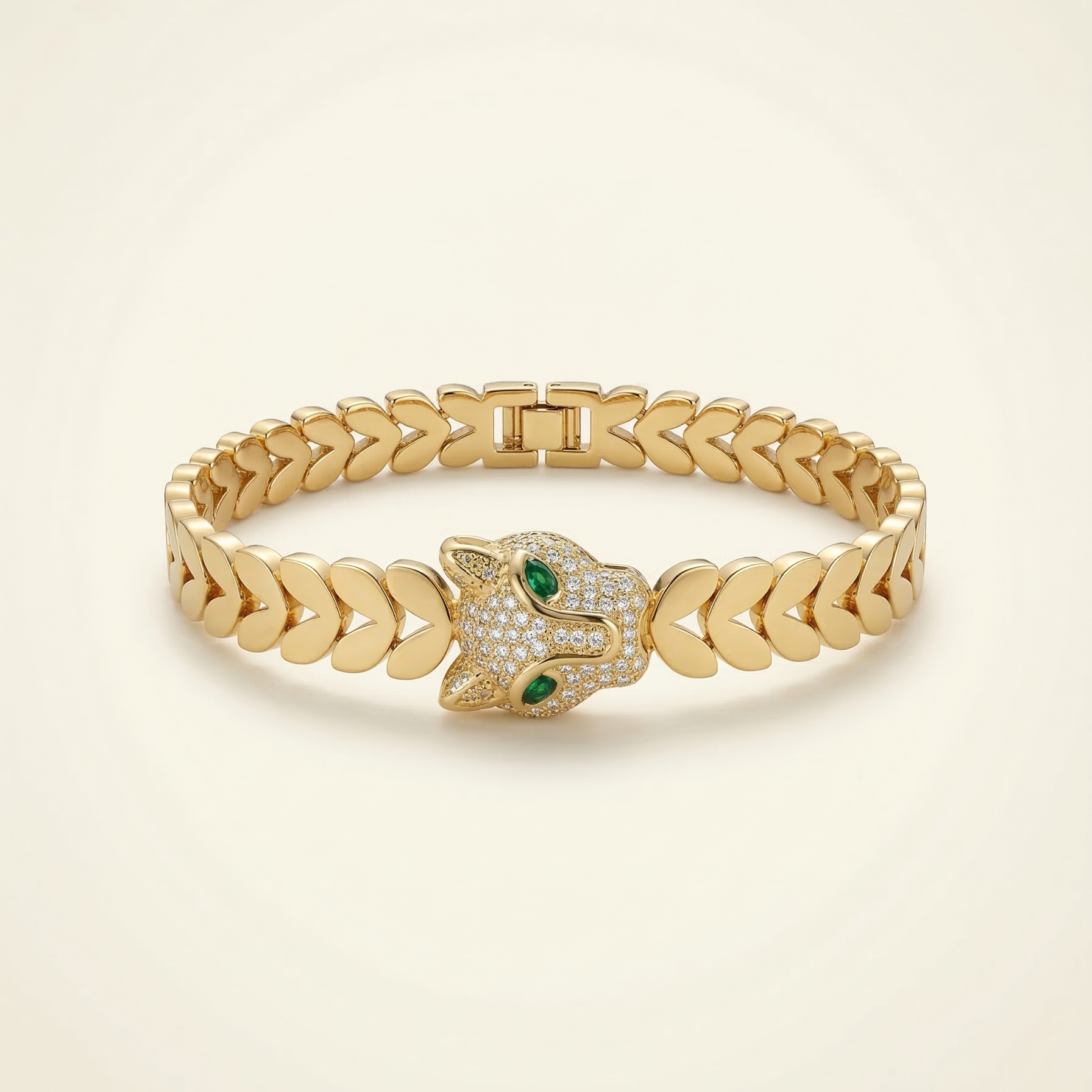 Gold bracelet with a hamsa design on a beige background