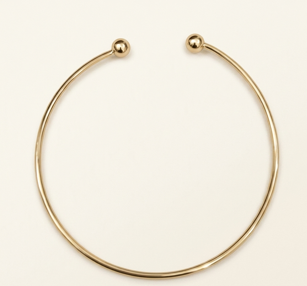 Gold necklace on a beige background