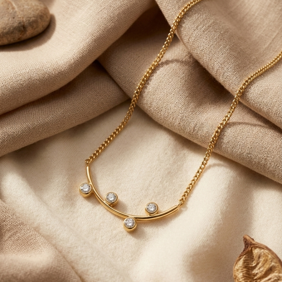 Gold necklace with gemstones on a beige fabric background