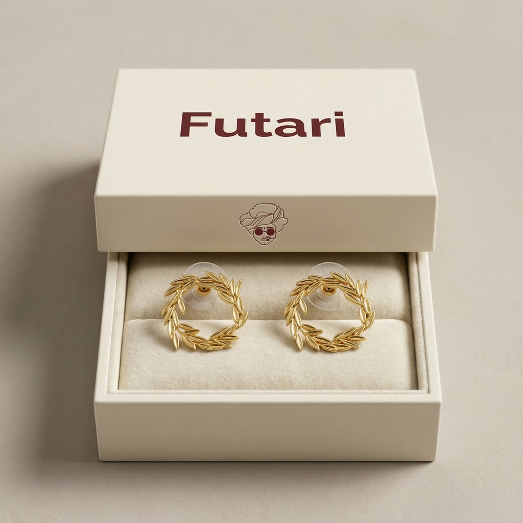 Gold earrings in a 'Futari' branded box on a beige background