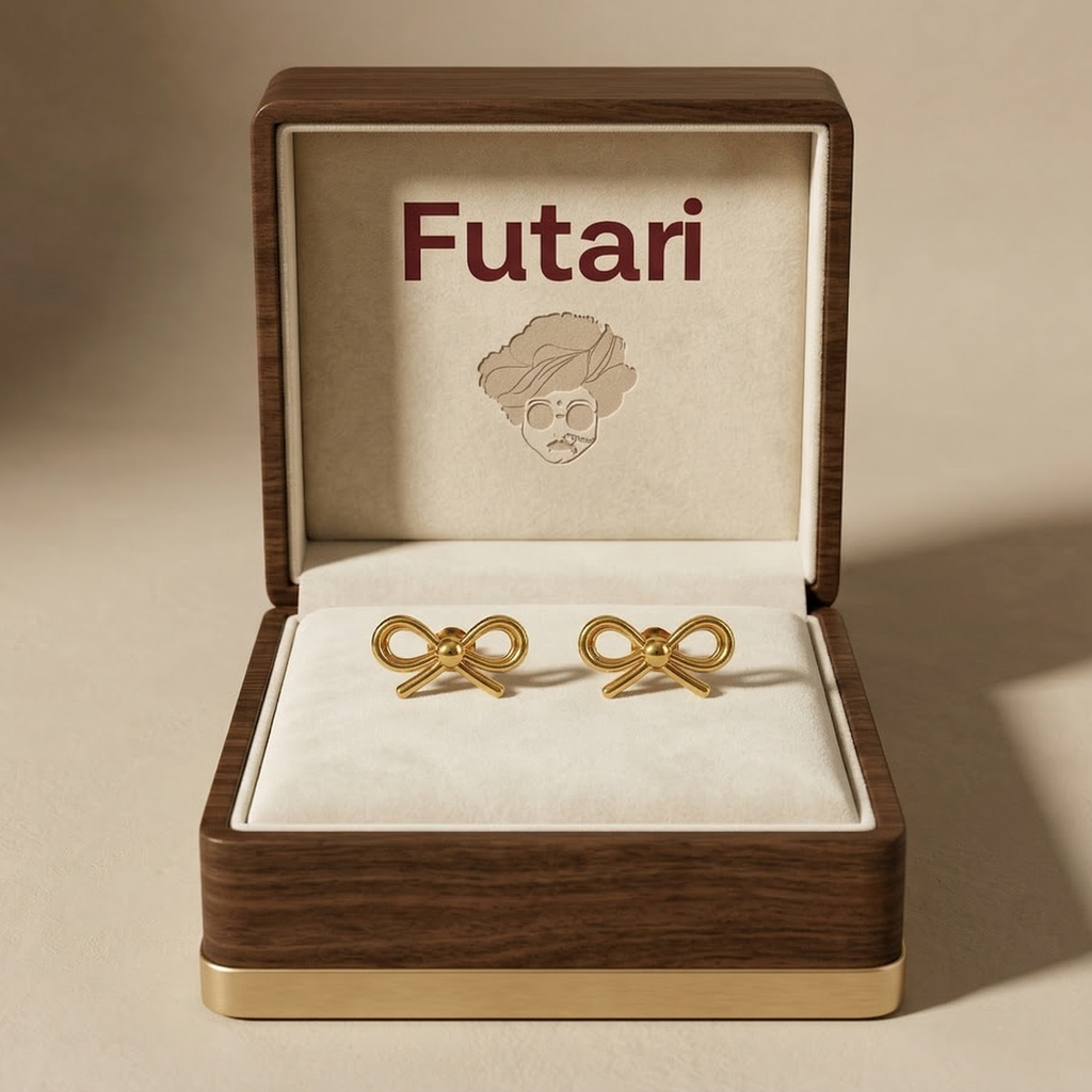 Gold bow-shaped earrings in a wooden box with 'Futari' branding.
