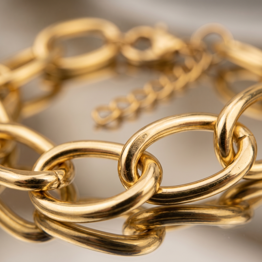 Gold chain bracelet on a neutral background
