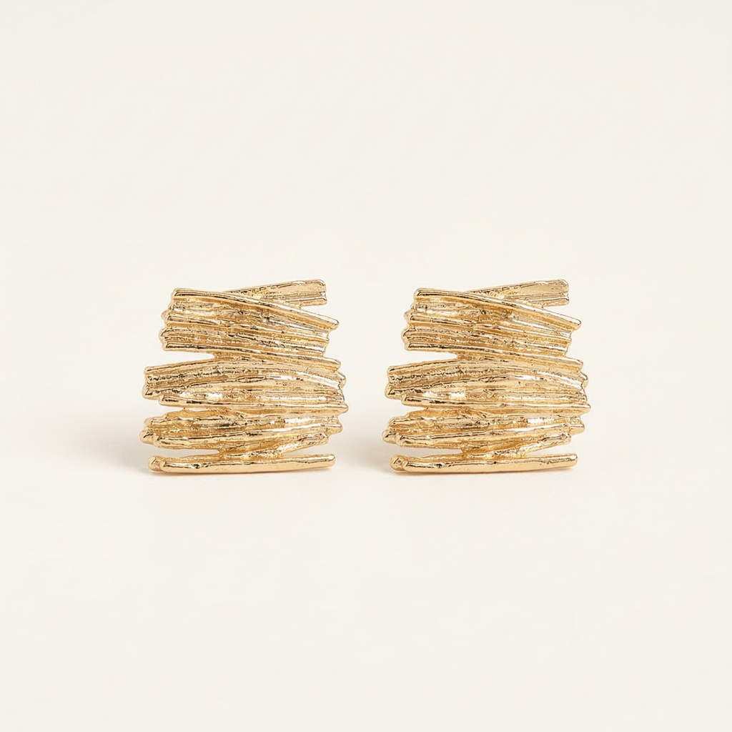 Pair of gold hoop earrings on a white background