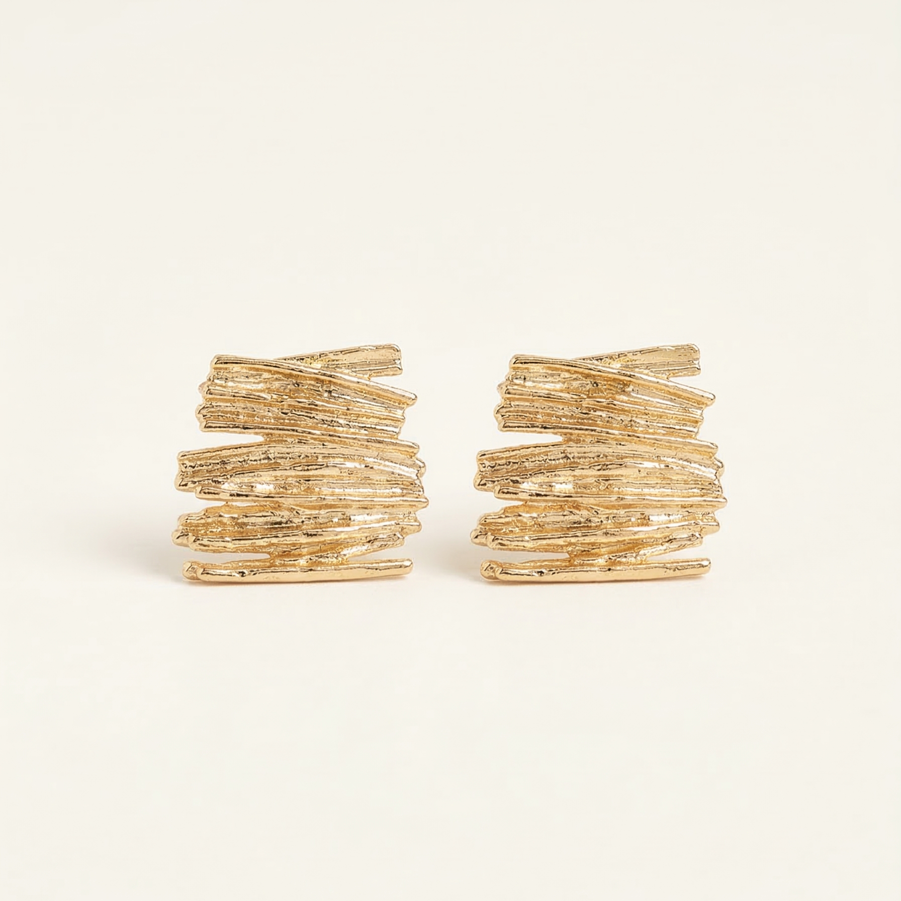 Pair of gold hoop earrings on a white background