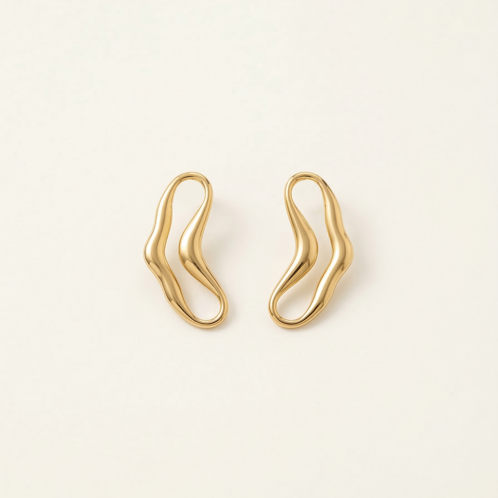 Pair of gold earrings on a light beige background