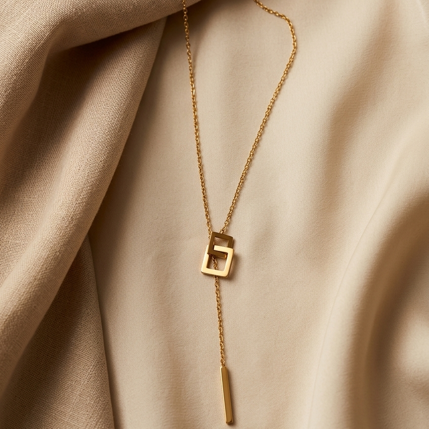 Gold necklace with a unique pendant on beige fabric