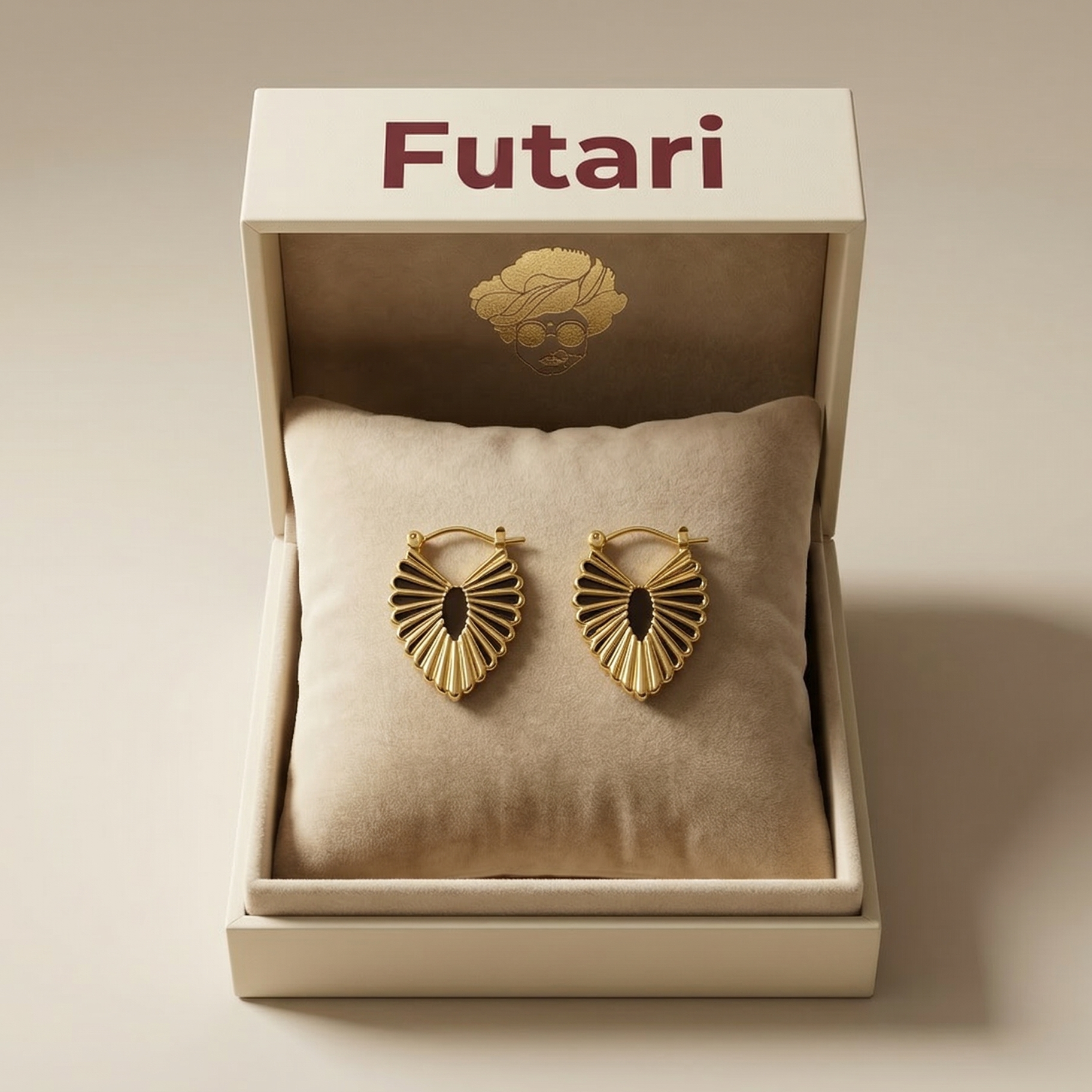 Gold earrings in a 'Futari' branded box on a beige background