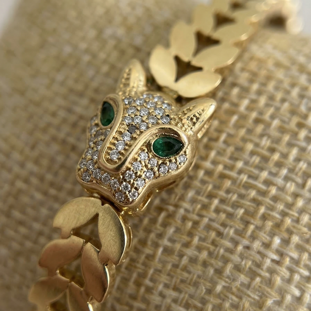 Gold bracelet with a fox head design on a textured beige background