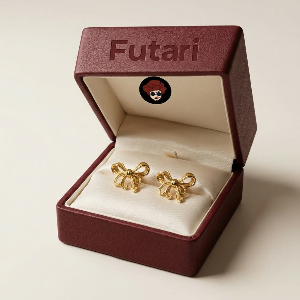 Gold earrings in a 'Futari' branded box on a beige background