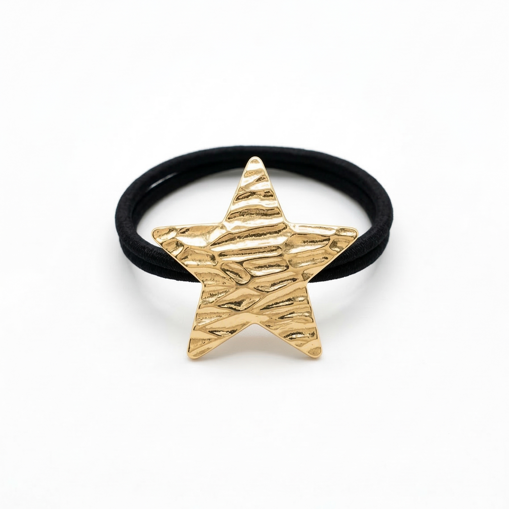Black hair tie with a gold star-shaped clip on a white background