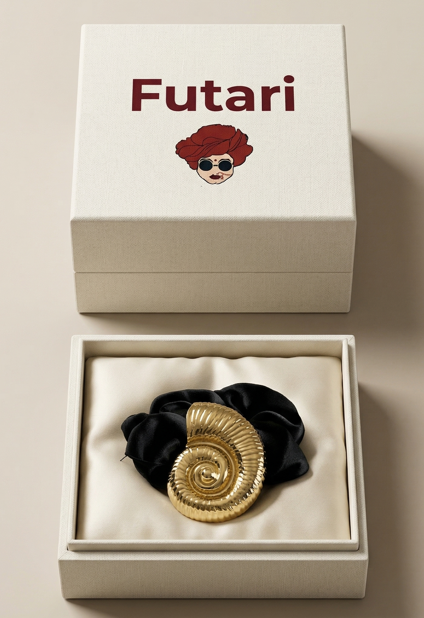 Gold spiral hair tie in a white box with 'Futari' branding on a beige background