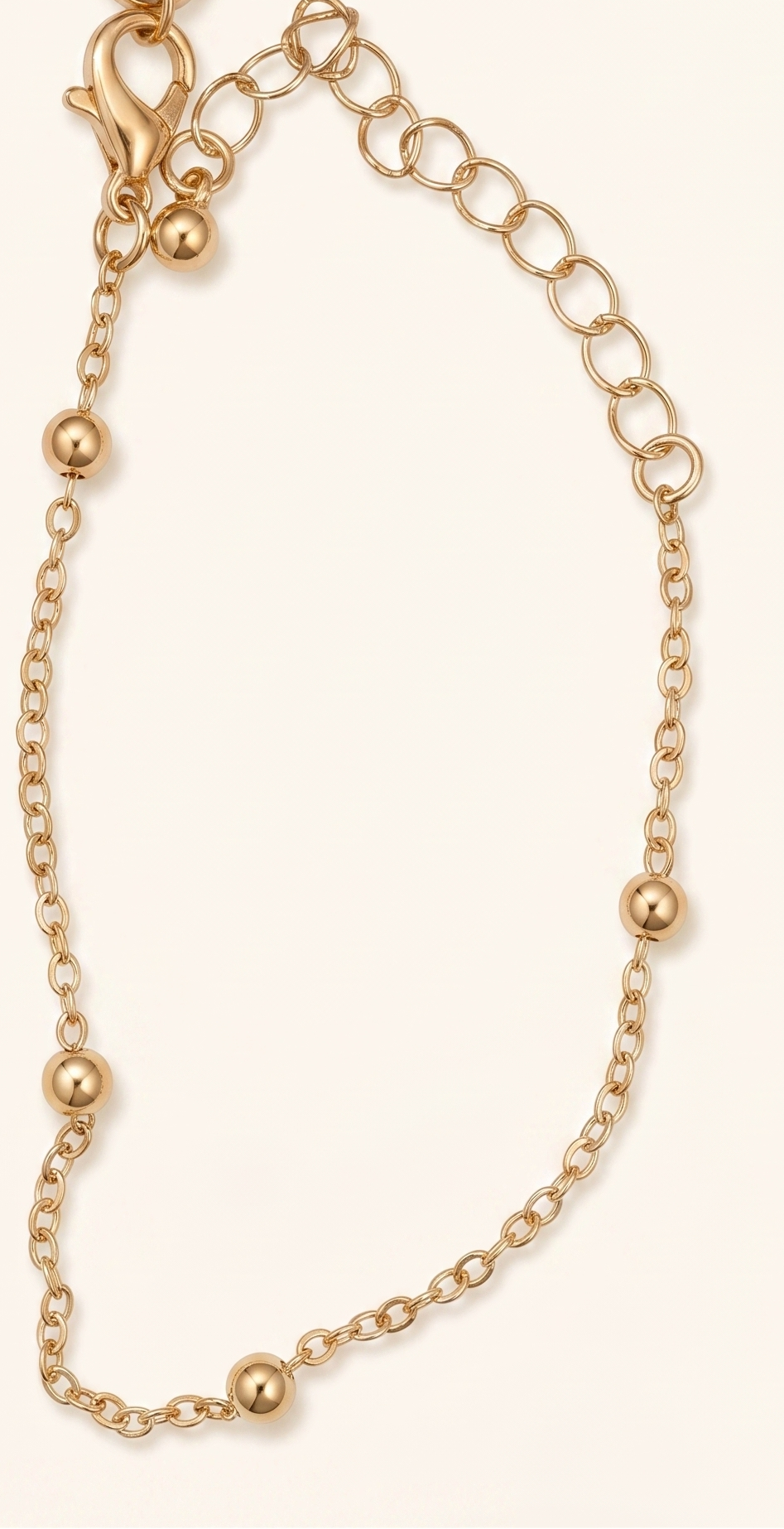 Gold bracelet on a beige background