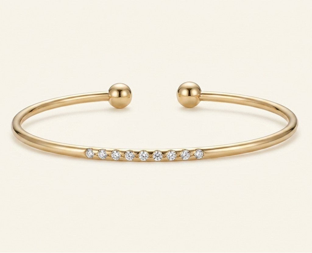 Gold bracelet with small crystals on a beige background