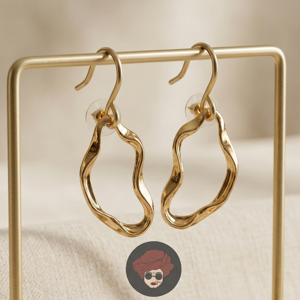 Gold hoop earrings on a gold stand with a blurred background