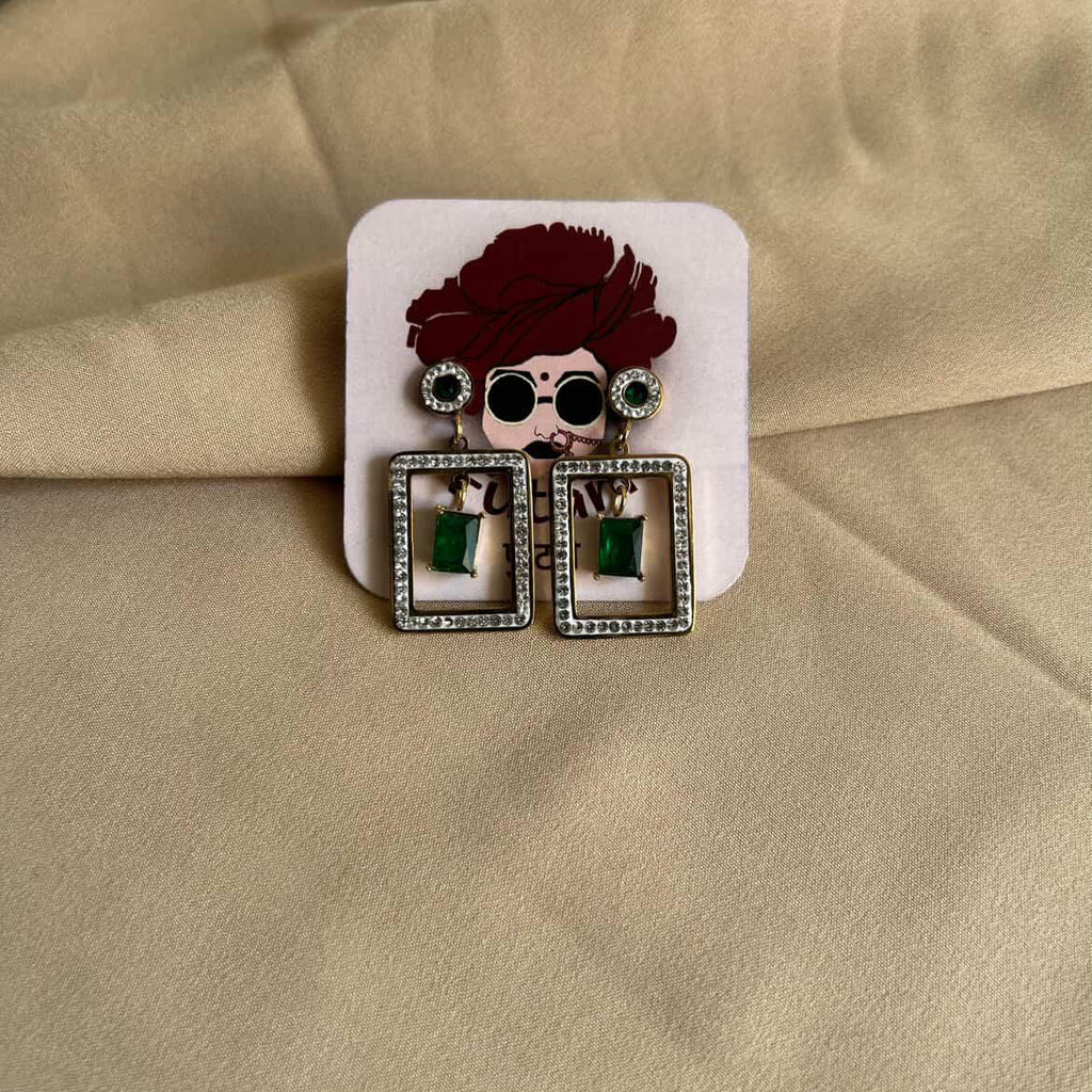 Earrings with a hair accessory on a beige fabric background