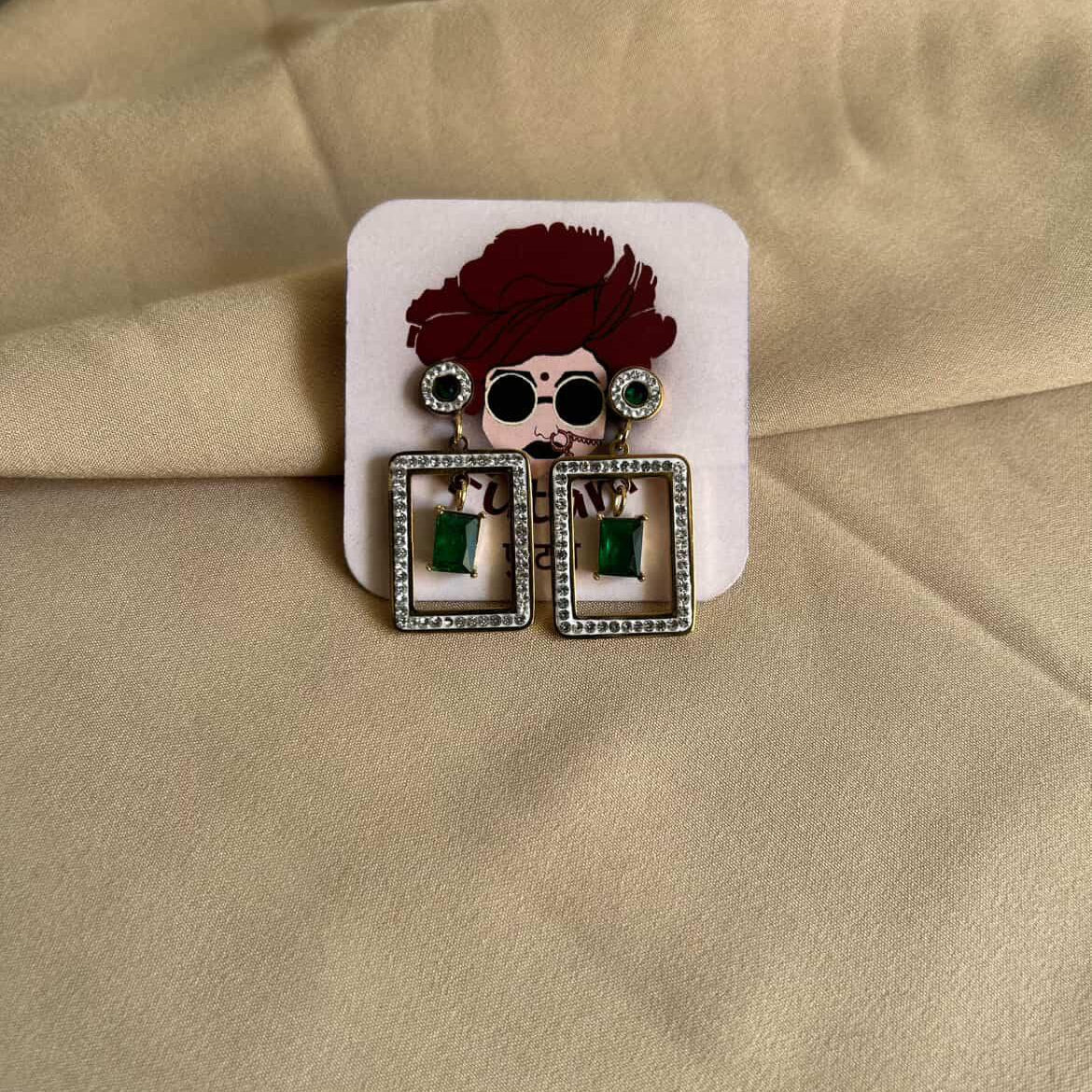 Earrings with a hair accessory on a beige fabric background