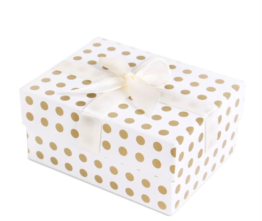A rectangular gift box wrapped in white paper with evenly spaced gold polka dots and tied with a white satin ribbon bow, shown on a plain white background.